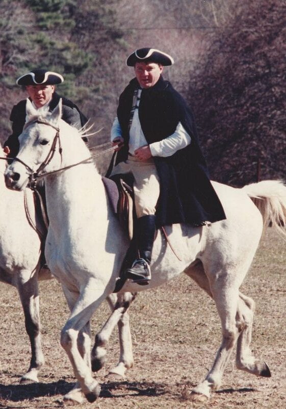 2 lancers riding white horses